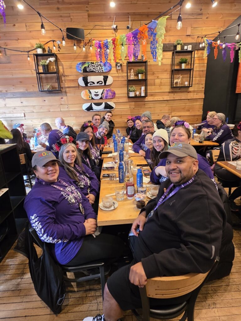 A group of Antares employees at a restaurant. They are each sporting a medal.