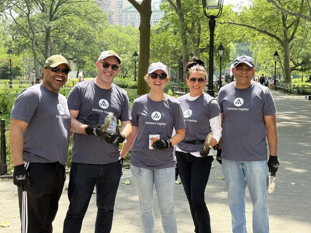 A group of Antares employees in the park, smiling.