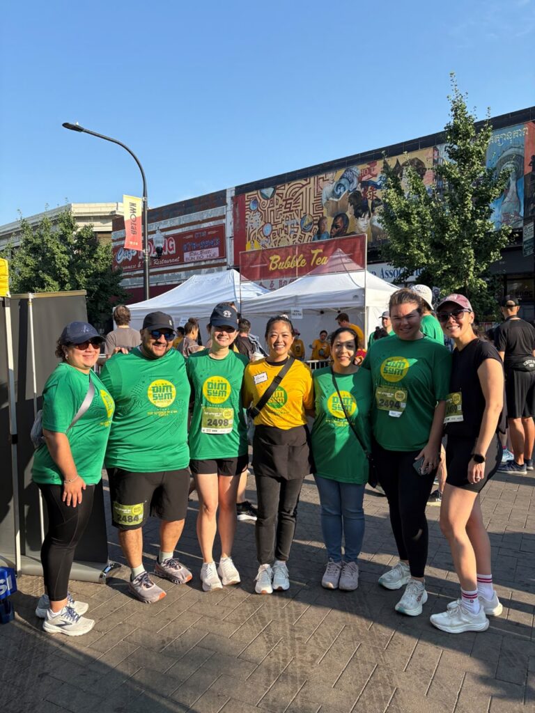 A group of Antares employees posing together at a running race.