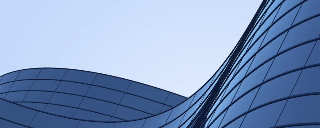 A skyscraper against a blue sky.