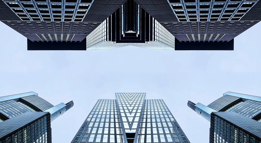 Multiple glass skyscrapers against a clear, blue sky.