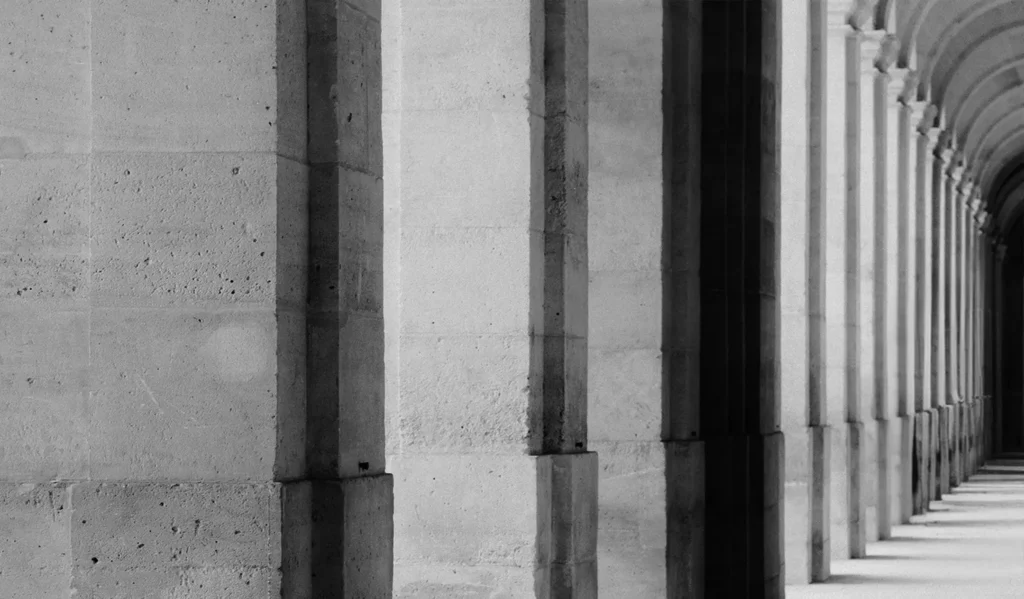 A black and white photograph of a row of columns.