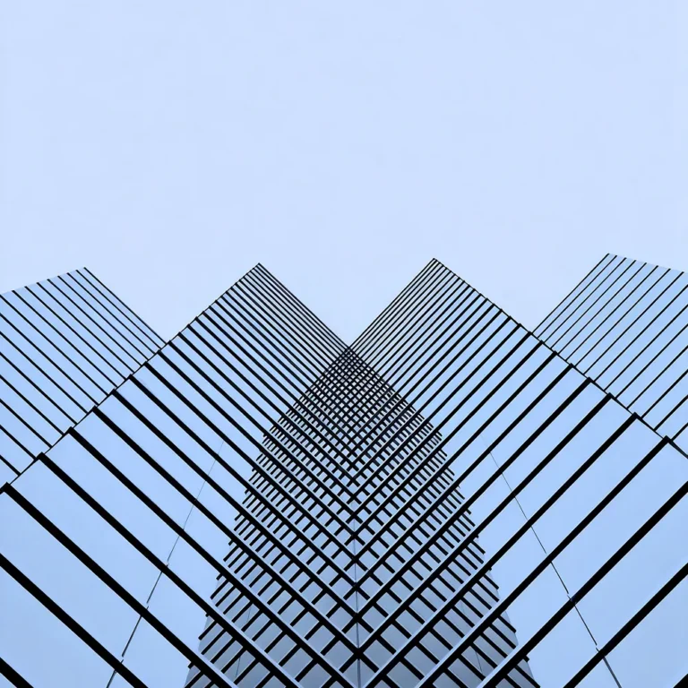 A glass skyscraper against a clear, blue sky.